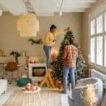 Photo of a couple decorating their Christmas tree