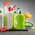 White and green cleaning kit on gray background.