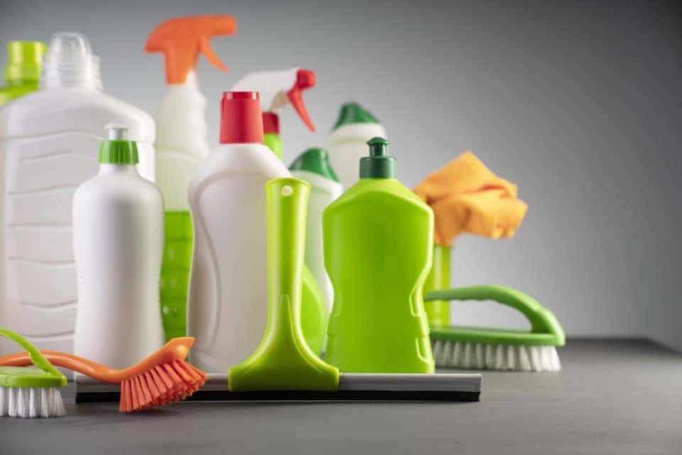 White and green cleaning kit on gray background.