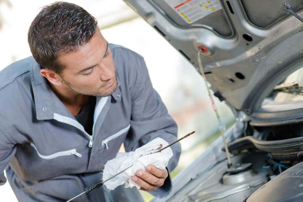Technician changing oil in a MINI at MINI of Manhattan near Newark NJ