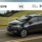 Buick Encore driving past field