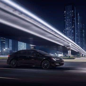 Toyota_Corolla_Driving_In_City_At_Night