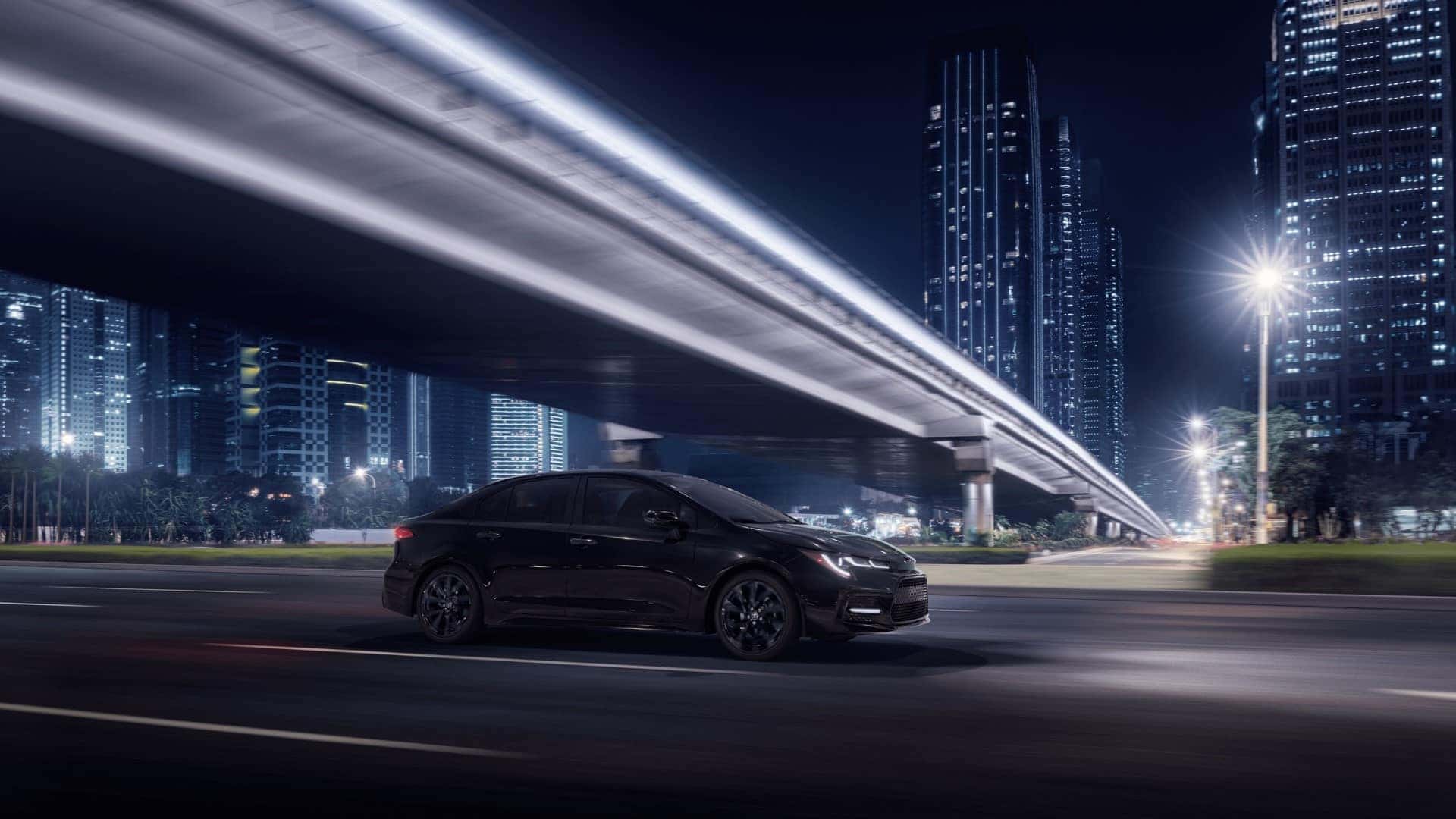 Toyota_Corolla_Driving_In_City_At_Night