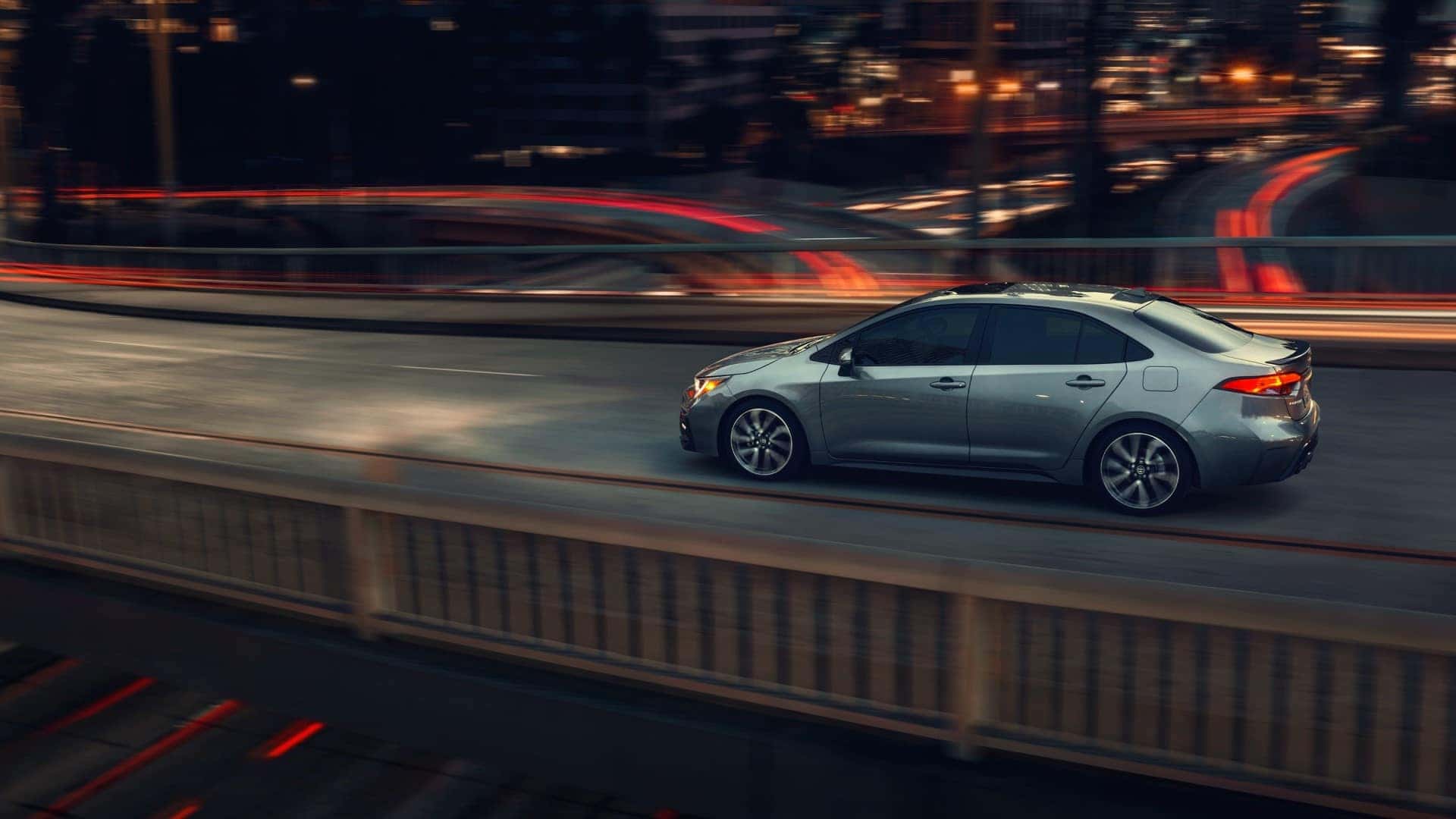 Toyota_Corolla_Driving_In_City_On_Bridge