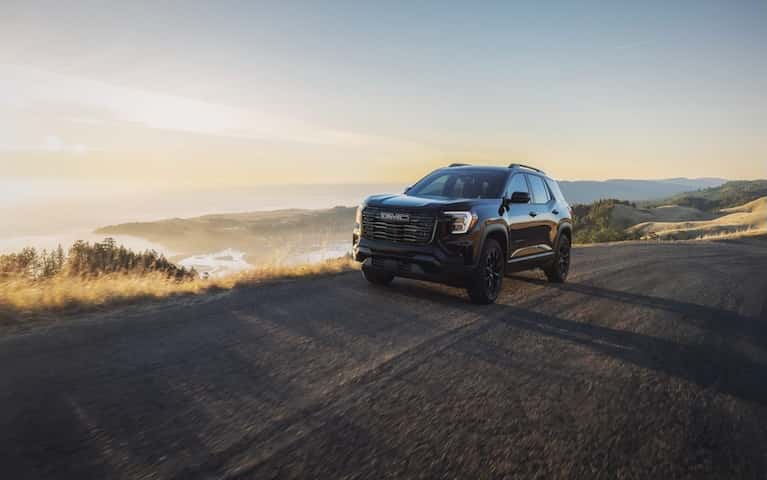 GMC vehicle driving down a road