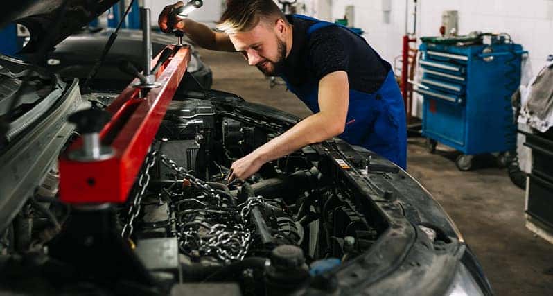 Defining MOPAR at Stetler DCJR in York, PA | Mechanic installing rebuilt engine into vehicle 
