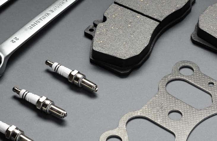 3 Main Benefits of Using OEM parts for your vehicle at Stetler DCJR in York, PA | Close up of multiple car parts(spark plugs, brakes, gasket) on a flat surface