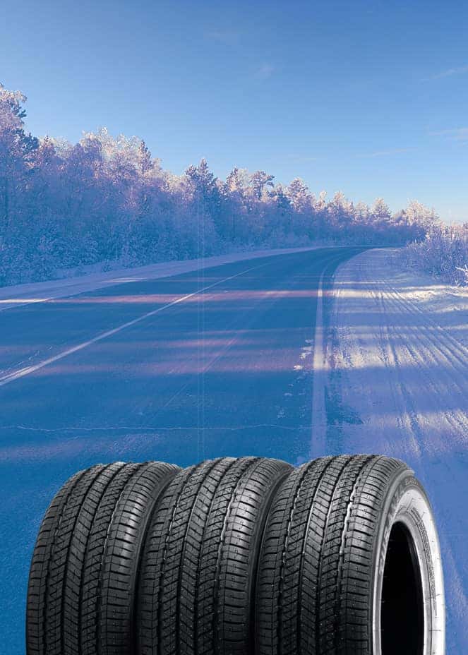 The Cold Facts of Winter Tires | Stetler DCJR in York, PA | Winter tires stacked together with a background of a winter road empty