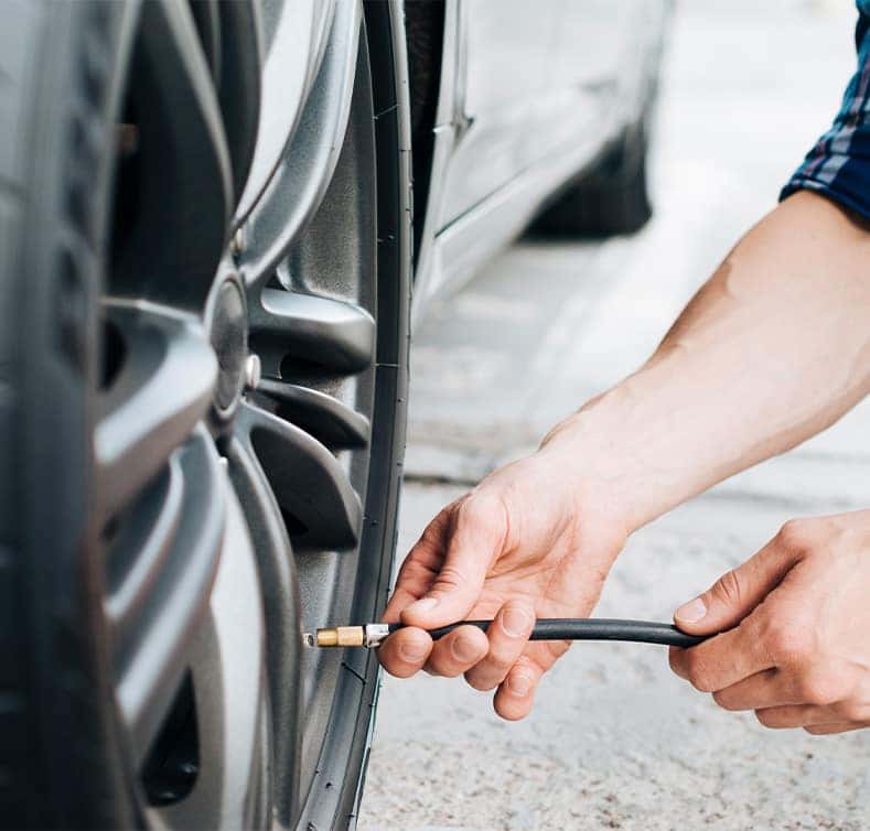 Tire Pressure Information at Stetler DCJR in York, PA | Person putting air into tire using a tire pressure tool