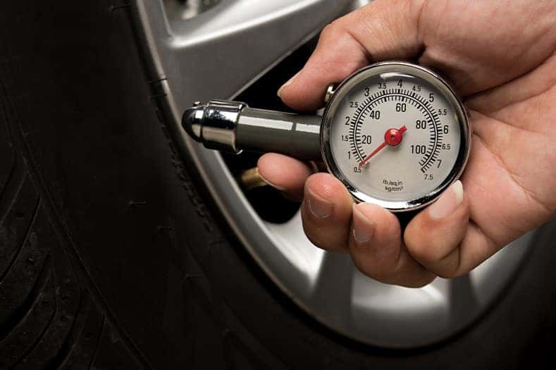 Tire Pressure Information at Stetler DCJR in York, PA | Person holding tire pressure tool