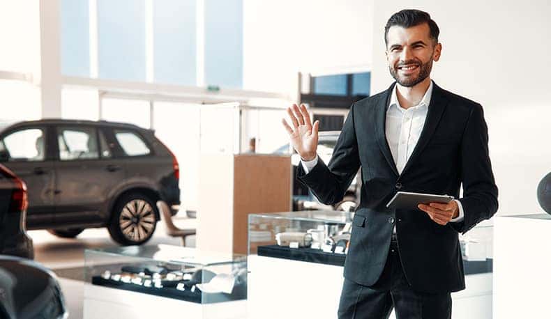 The Advantages of Buying a Car from a Dealership vs. a Private Seller. Learn more at Stetler DCJR in York, PA | Salesman waving goodbye in a dealership