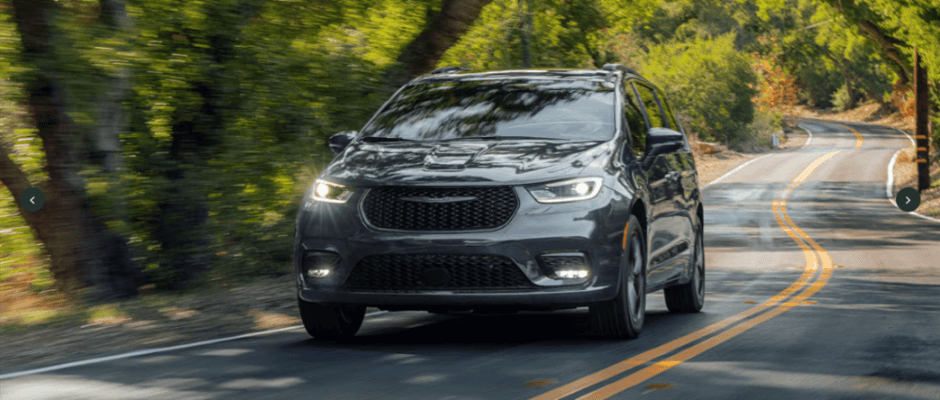 A gray Chrysler Pacifica driving down the road.