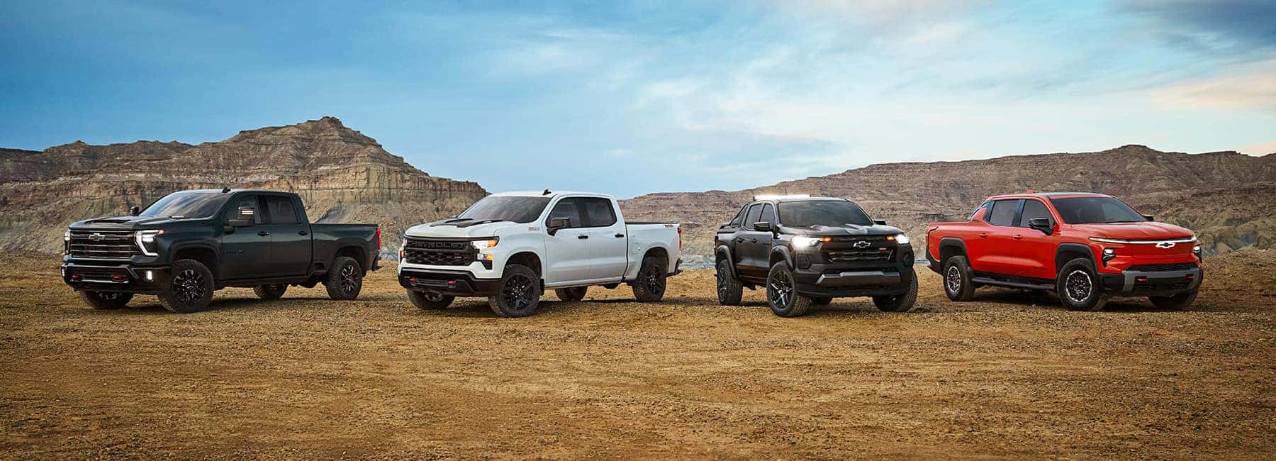 Four-Chevrolet-Trucks-Parked-in-the-Dirt