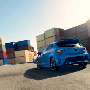 Toyota_Corolla_Hatchback_Blue_Driving_Rear_View