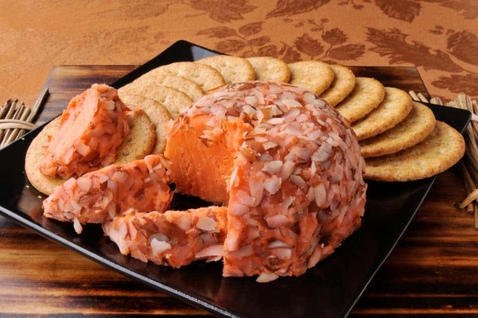 A cheese ball and crackers on a plate