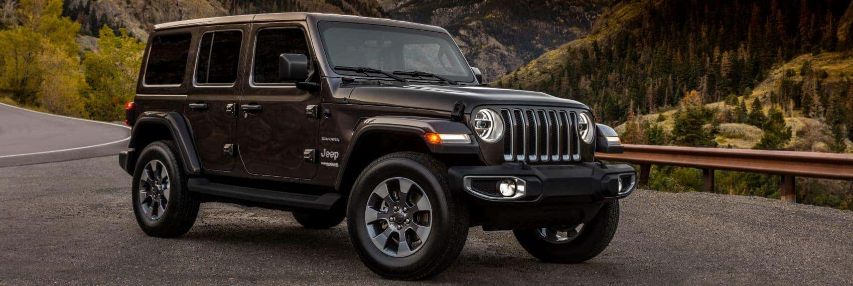 Jeep Wrangler parked at a mountain lookout