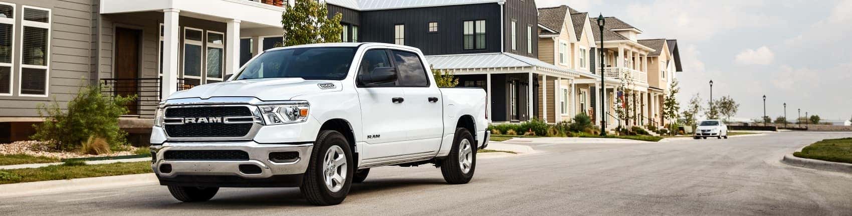 2021 Ram 1500 white driving through apartment complex banner