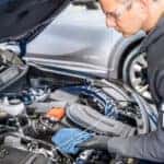 Buick Certified Technician checks the oil in a buick
