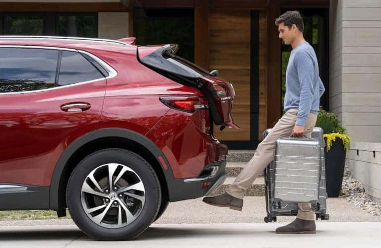 Man Holding Luggage Using Hands-Free Liftgate on 2023 Buick Envision