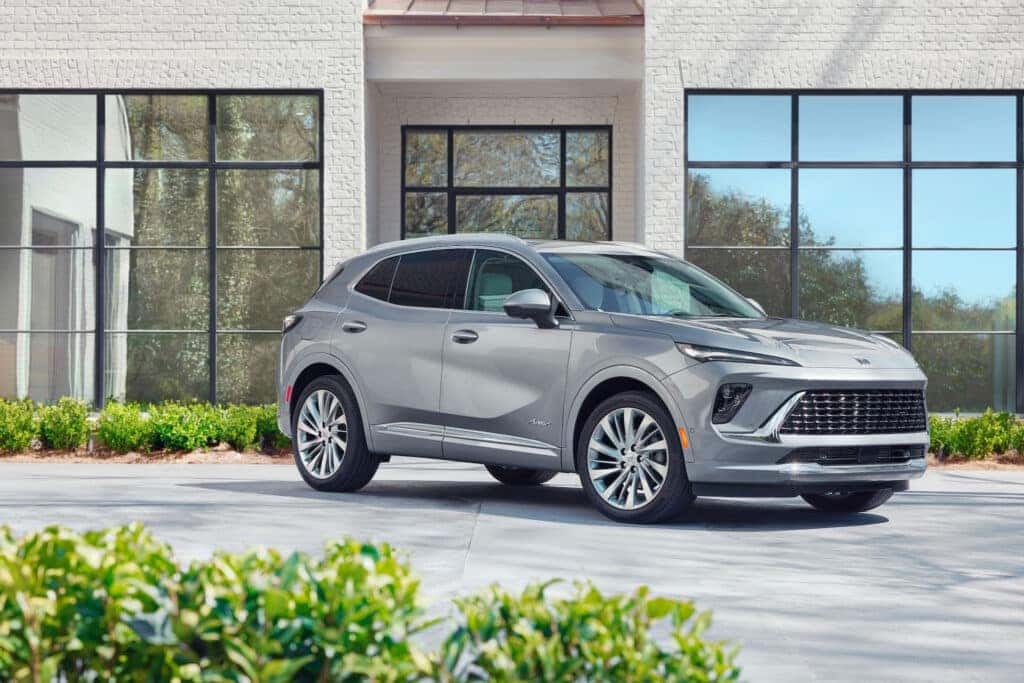 Front 3/4 view of the 2024 Buick Envision Avenir in Moonstone Gray Metallic. Preproduction model shown. Actual production model may vary. Available in Q1 of 2024.