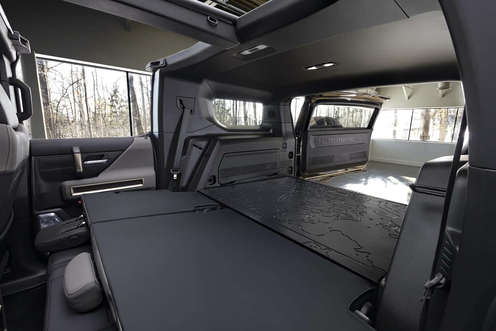 The GMC HUMMER EV SUV debuts in the low-contrast Lunar Shadow interior and includes a spacious cargo area and an architecturally inspired cabin.