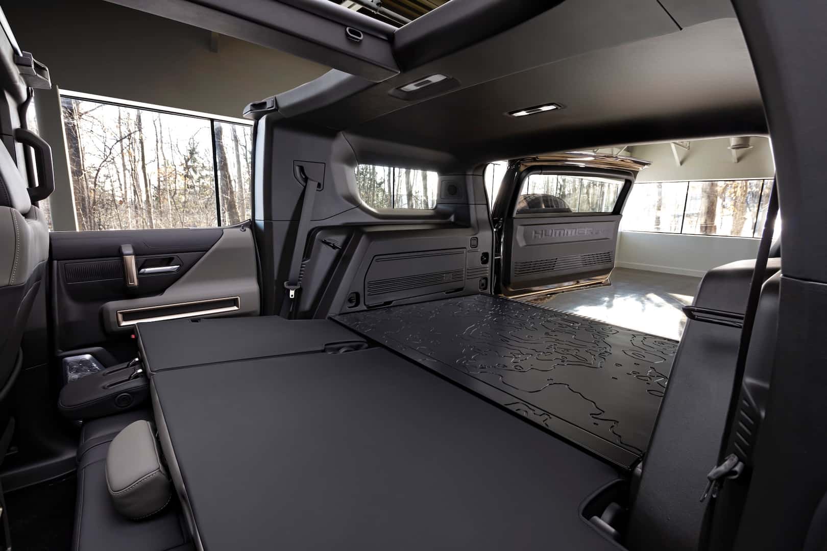 The GMC HUMMER EV SUV debuts in the low-contrast Lunar Shadow interior and includes a spacious cargo area and an architecturally inspired cabin.