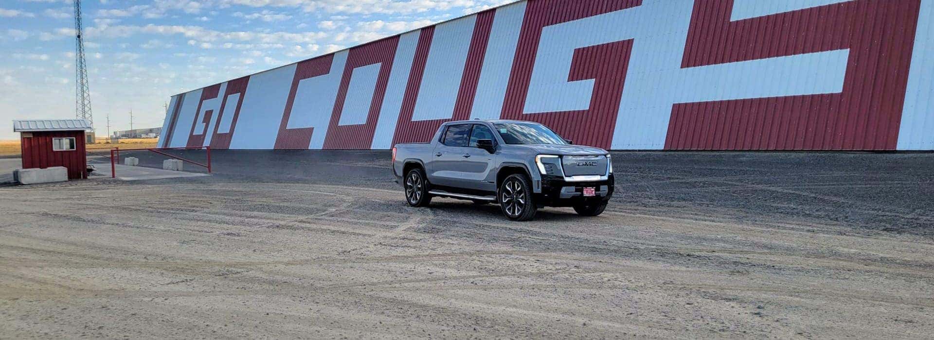 Electric truck next to go couger sign