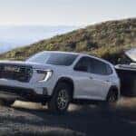 2024 GMC Acadia towing a camper with kayaks