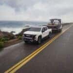 2026 GMC Sierra EV AT4 Towing a Boat