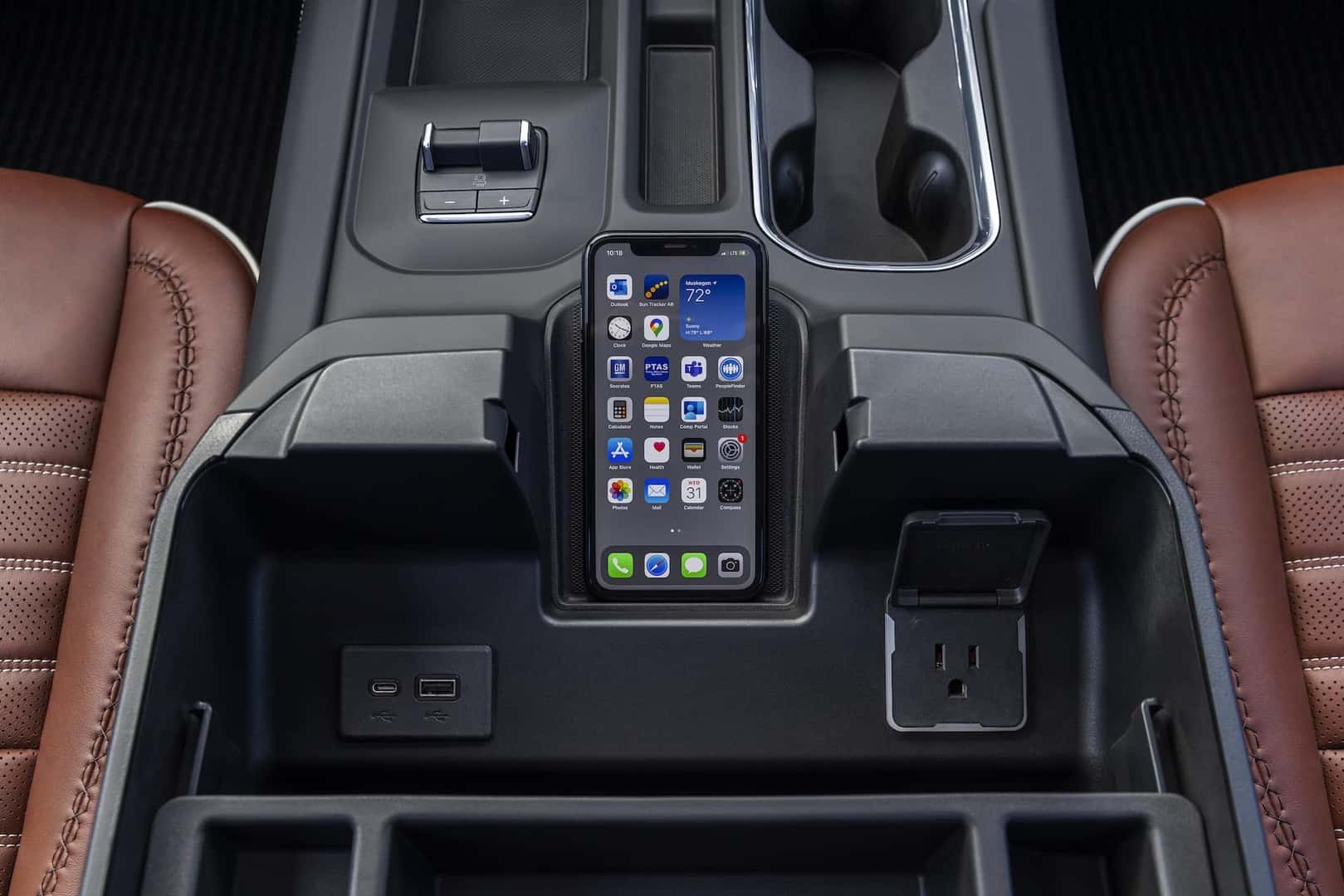 Interior close-up shot of the GMC Sierra 2500 HD Denali Ultimate center console and wireless phone charger