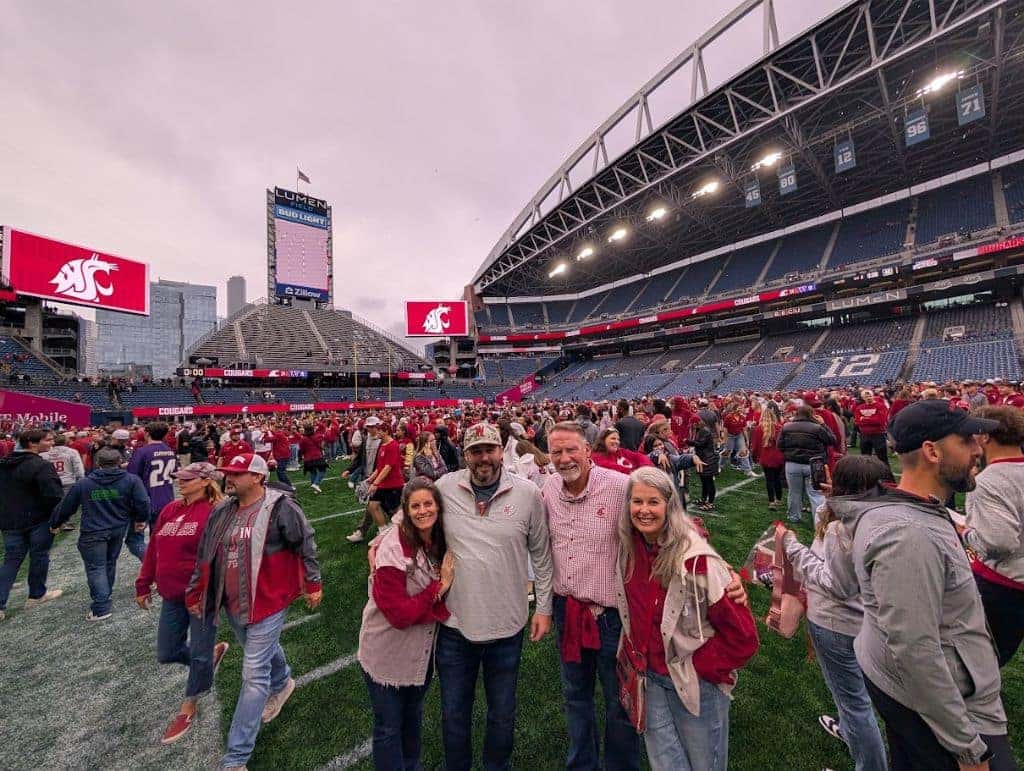 Bryant and Ron on the field after the 2024 Apple Cup win for WSU.