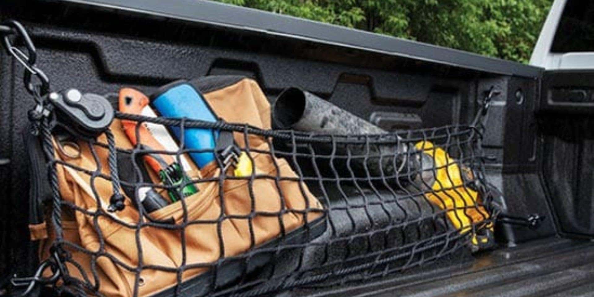 Cargo net storage organizer stores gear in the back of a pick up truck bed from Valley GMC in Auburn WA