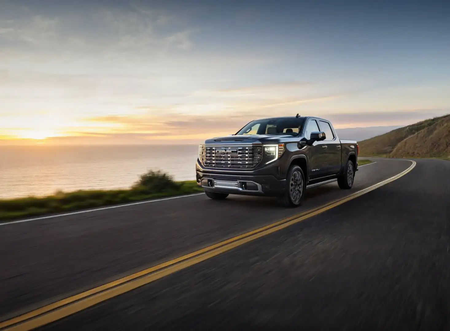 2024 GMC Sierra Denali Ultimate driving on a road