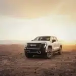 White 2026 GMC Sierra EV parked off road in the desert