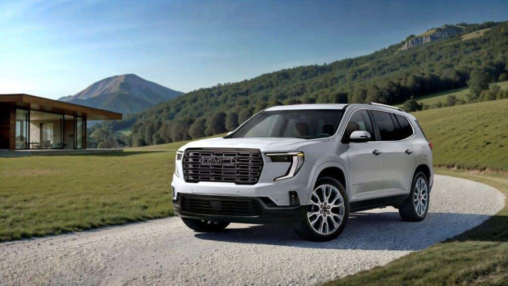 The Impressive 2026 GMC Acadia Denali Ultimate Driving Out Of The Winding Drive Way