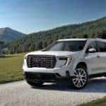 The Impressive 2026 GMC Acadia Denali Ultimate Driving Out Of The Winding Drive Way