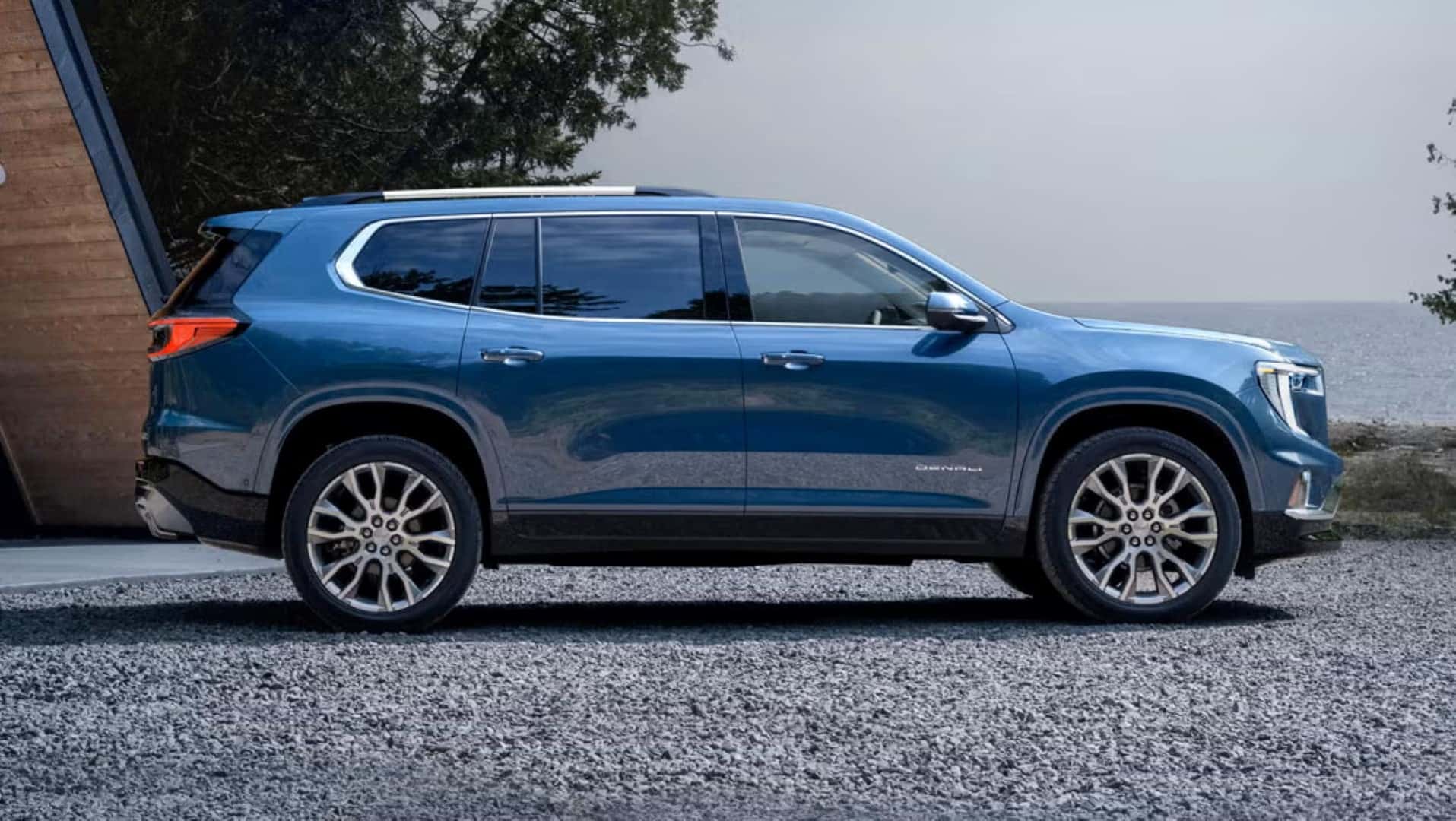 The Shining Side Profile Of The Fantastic GMC Acadia, Parked In A Gravel Driveway