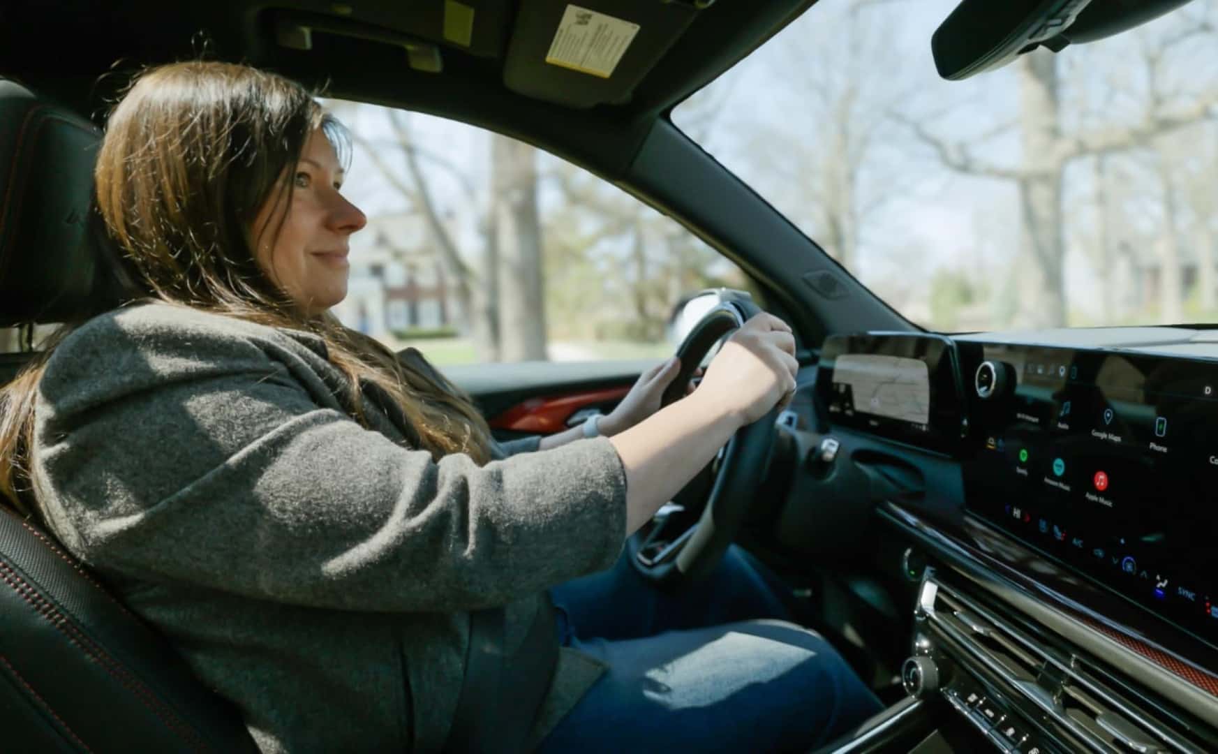 A Vigilant Woman Driving Her General Motors Vehicle With Safety Mind