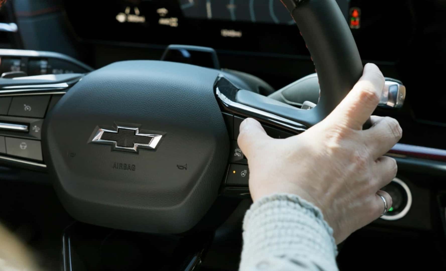 A Knowledgeable Driver Using A Safety Feature By Pressing A Button on The Steering Wheel