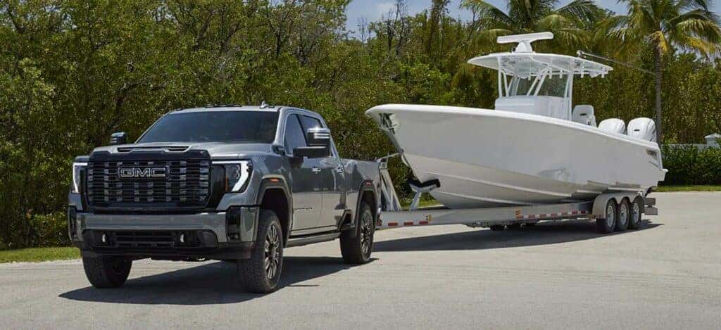The Powerful GMC Sierra 1500 Towing A Dependable, White Boat