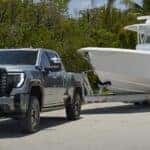 The Powerful GMC Sierra 1500 Towing A Dependable, White Boat
