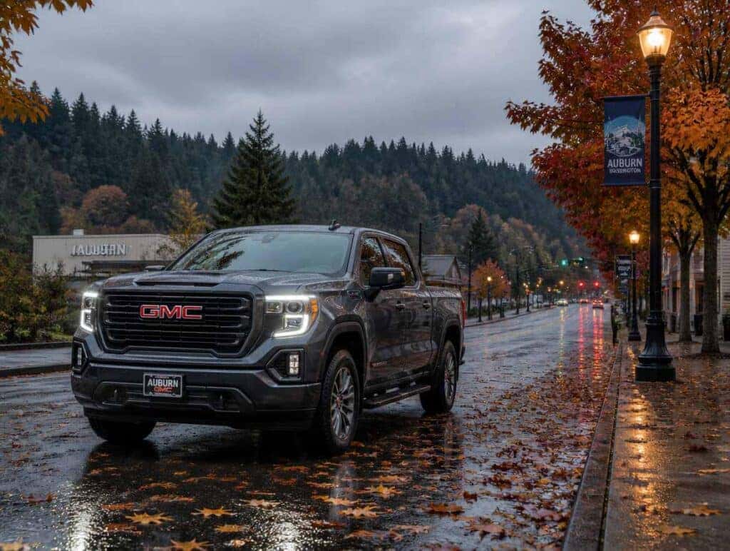 2026 GMC truck on wet leaf-covered road in Auburn WA fall rain