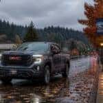 2026 GMC truck on wet leaf-covered road in Auburn WA fall rain