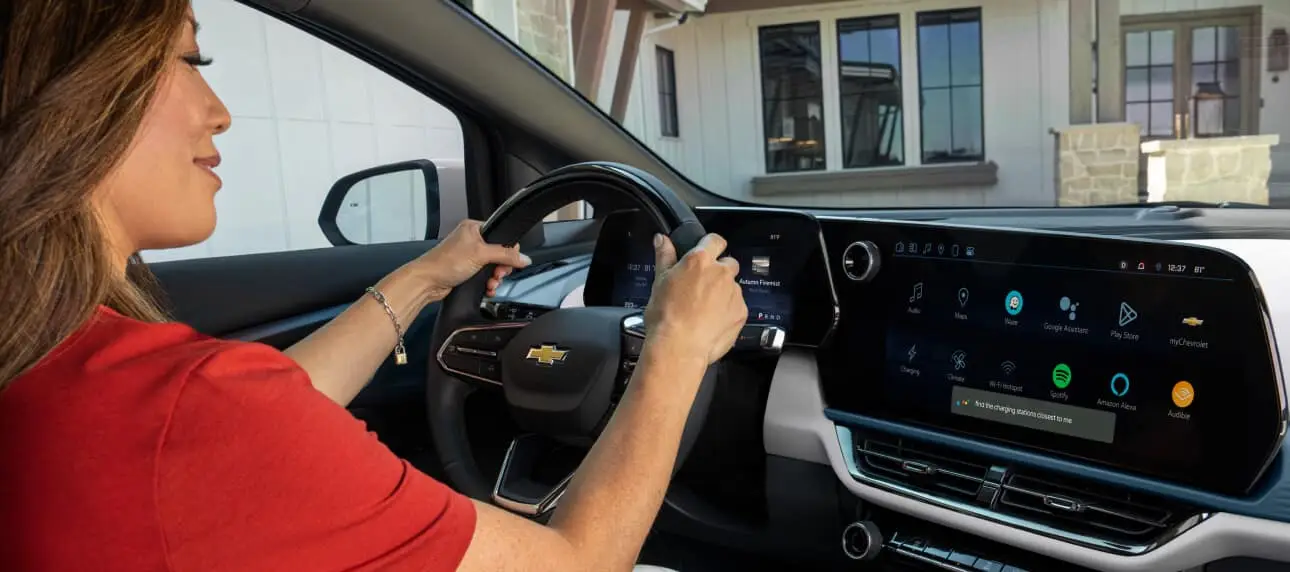 Woman smiling behind steering wheel