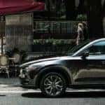 Man Walking by a Mazda CX-5 Parked on Side of Road
